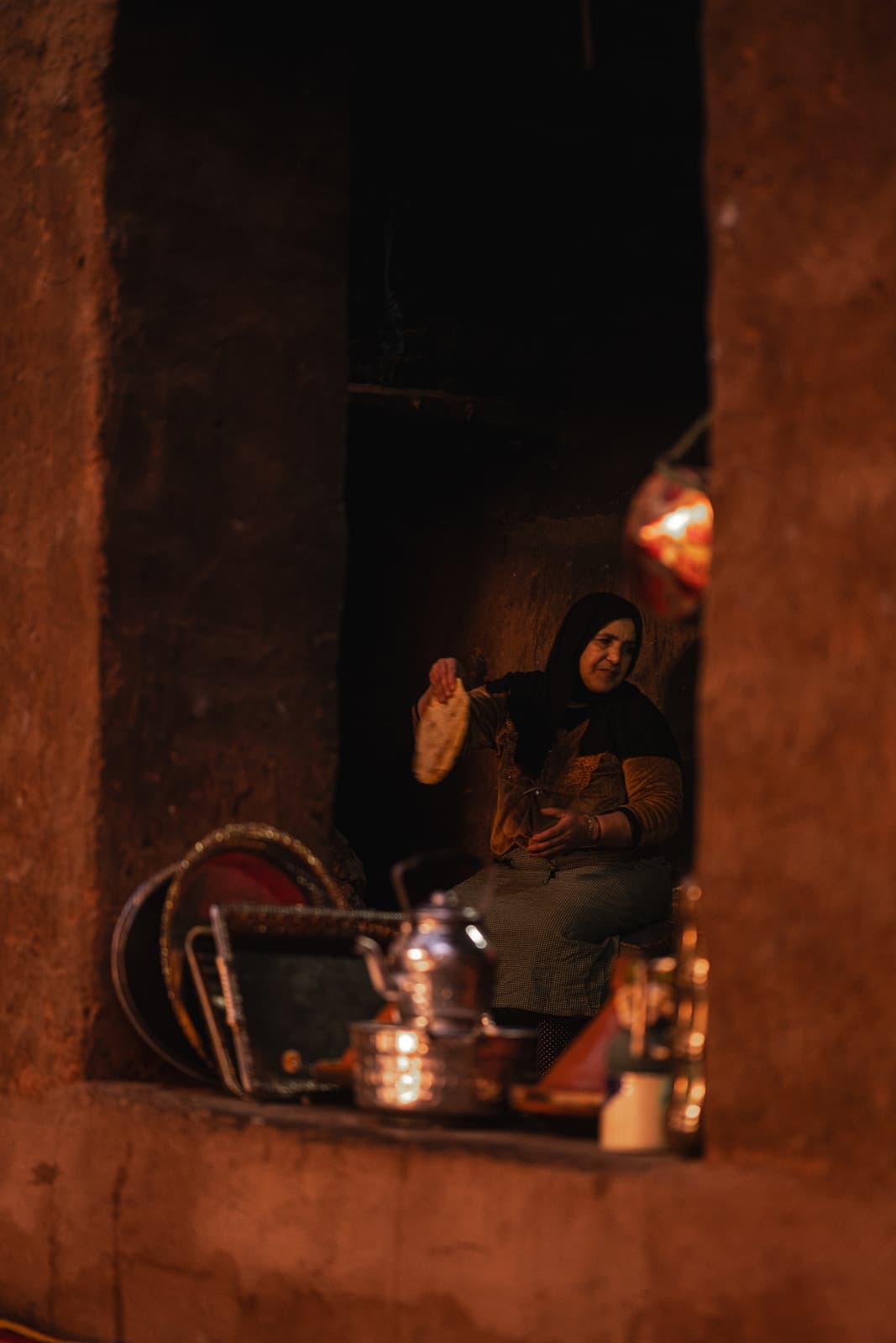 Hand pouring tea from silver teapot