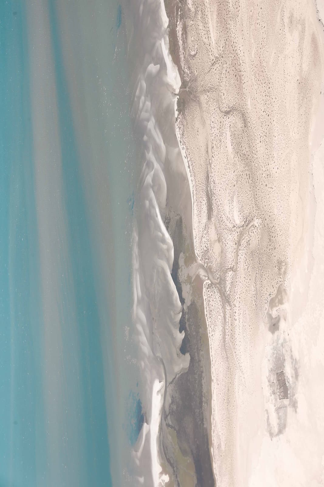 Aerial view of sand dune meeting sea