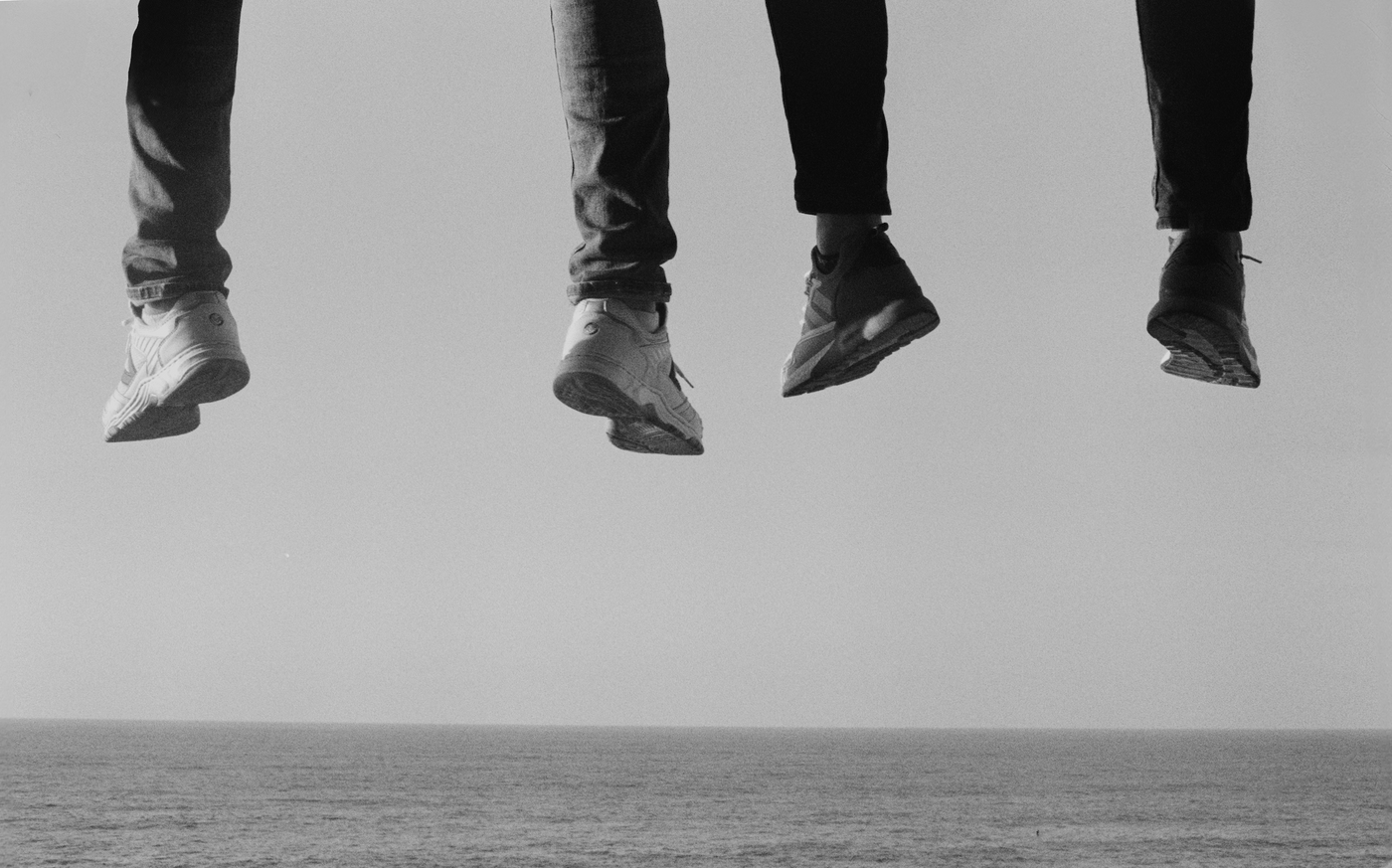 Three pairs of legs mid-jump